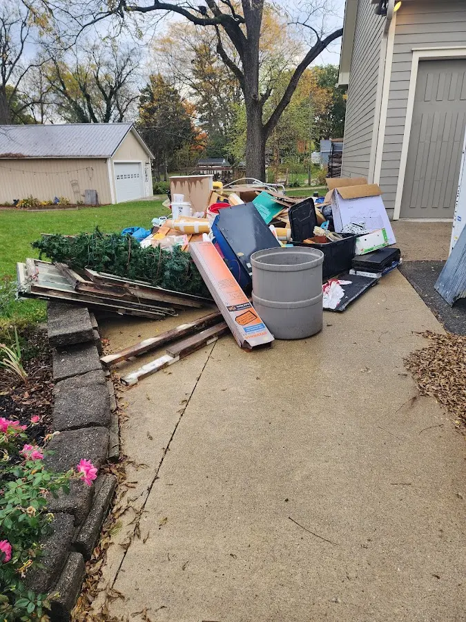 Dumpster being loaded with debris for Estate Cleanout Dumpster Rental in Fish Hawk